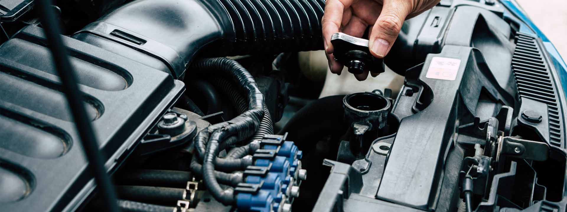 Hands checking the coolant and cooling system on an engine