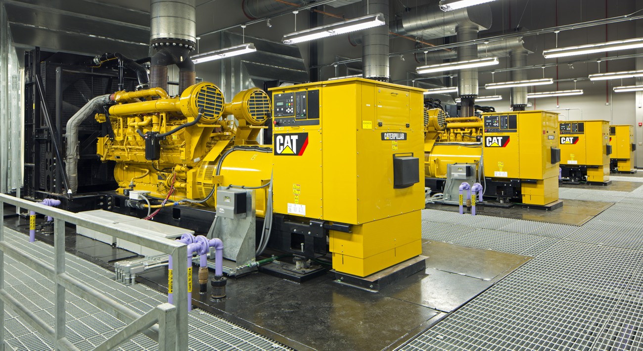 Row of CAT industrial generators in a plant room