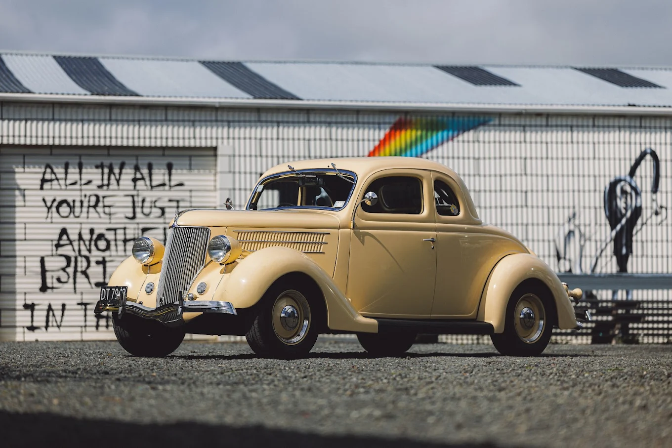 Restored cream vintage hot-rod coupe parked outside